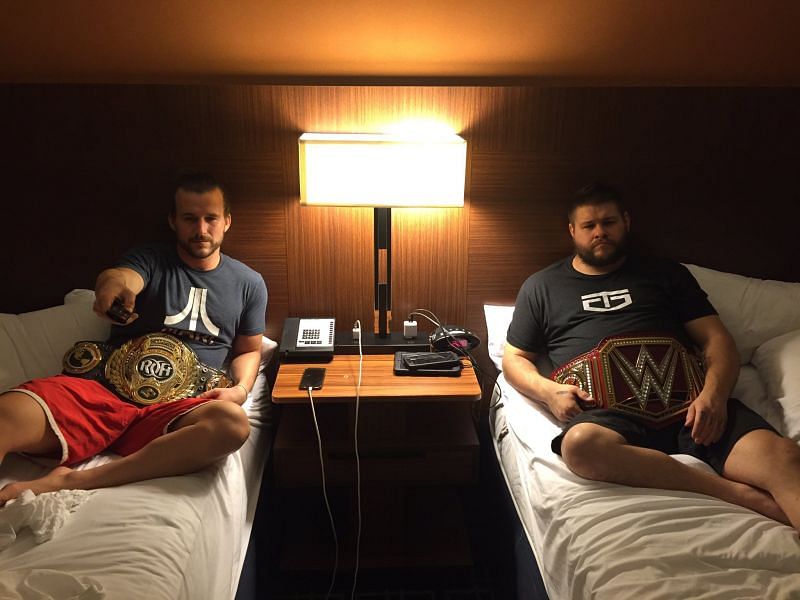 Adam Cole pictured with the ROH World TItle along with Kevin Owens with the Universal Title